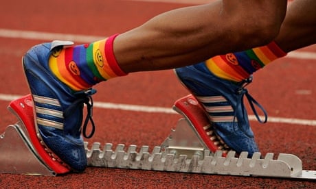 A runner with his feet in the starting blocks