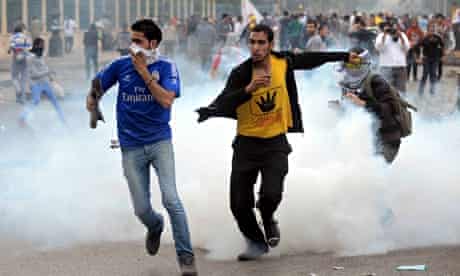 Mohamed Morsi supporters run away from teargas in Rabaa al-Adawiya square