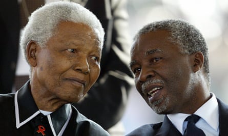 Thabo Mbeki, then South Africa's president, speaks with Nelson Mandela at the funeral of renowned anti-apartheid activist Walter Sisulu in 2003.