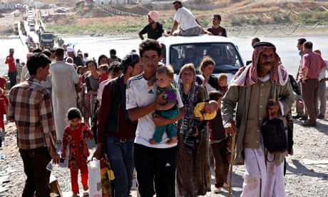 Displaced people from the minority Yazidi sect flee violence in the Iraqi town of Sinjar