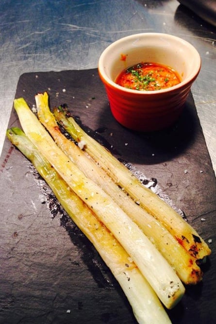 Baked spring onions in romesco sauce at Triciclo