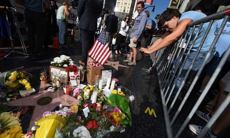 Flowers and momentos are left at a makeshift memorial to Robin Williams,  Hollywood Walk of Fame.