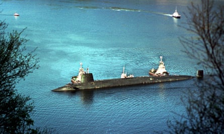 Trident nuclear submarine HMS Vengeance is escorted by tugboats into the naval base at Coulport, part of the Faslane complex.