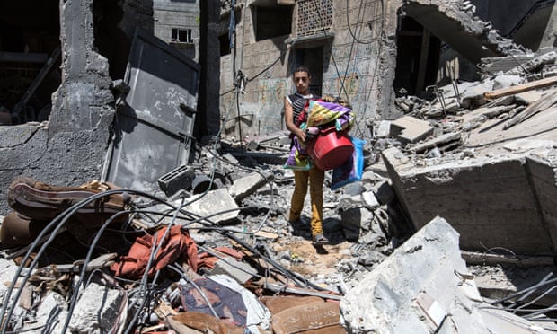 A Gaza resident returns to pick up belongings after his home was turned to rubble. Photograph: Sean Smith