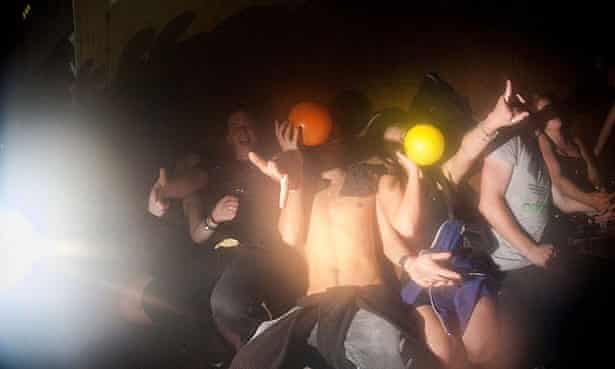 Clubbers breathing in laughing gas in a nightclub in Bristol.