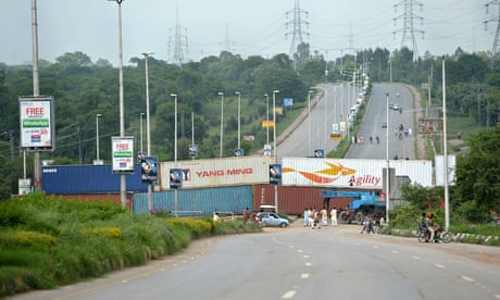 Police block a main road in Islamabad with shipping containers