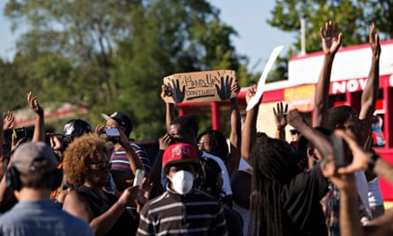 Demonstrators raise their hands while protesting against the killing of teenager Michael Brown