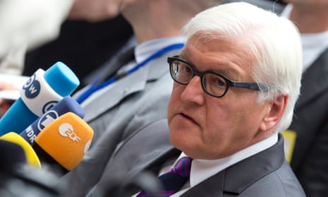 German Foreign Minister Frank-Walter Steinmeier speaks with journalists as he arrives for a meeting of EU foreign ministers in Brussels.