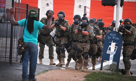 Armed police confront a protester in Ferguson, Missouri