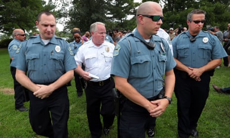 Ferguson Police Chief Tom Jackson leaves a news conference in Forestwood Park.