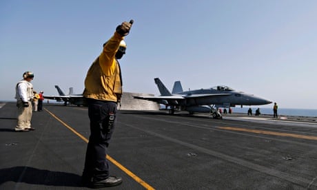 An American fighter launching from the USS George HW Bush to strike Isis targets in Iraq.