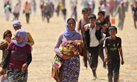 Yezidis trapped in the Sinjar mountains walk to safety