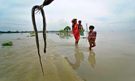 Nepalese villagers walk through floodwaters in Banke