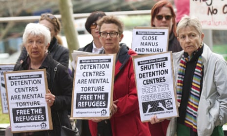 Protesters hold signs outside the department of immigration and citizenship, Sydney.