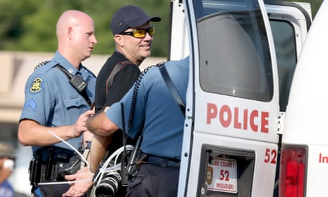 Scott Olson is placed into a police vehicle after being arrested while covering demonstrations in Ferguson.