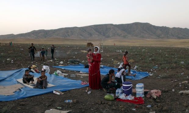 Displaced families from Iraq's Yazidi minority settle in a refugee camp.