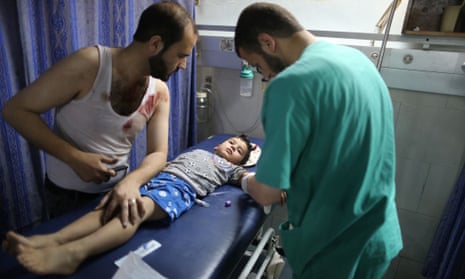 A boy is treated at al-Shifa hospital in Gaza after Israeli air strikes.