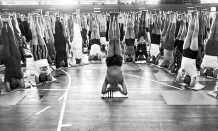Crowd of yoga enthusiasts doing headstands at Iyengar yoga convention in London