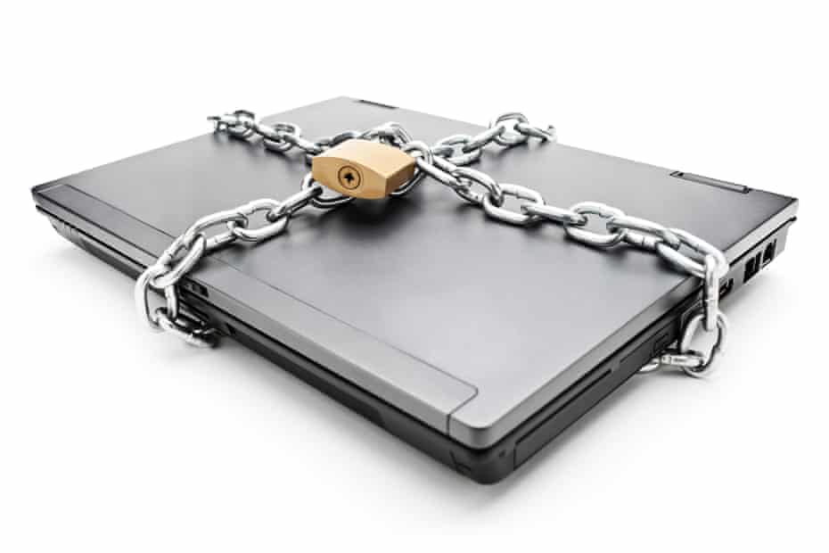 Heavy chain with a padlock around a laptop