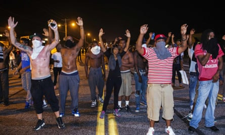 Demonstrators gesture with their raised in protest at the shooting of Michael Brown.