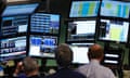 Traders work at Bloomberg terminals on the floor of the New York Stock Exchange. The company now integrates environmental, social and governance data into its analytical tools for investors.