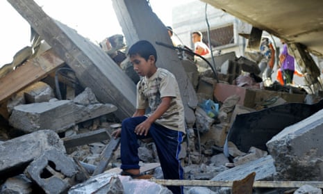 A Palestinian boy surveys damage after another night of air strikes on Gaza.