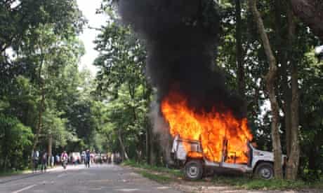 A police vehicle on fire in Golaghat, in the Indian state of Assam
