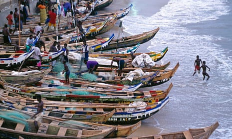 Ghana fishermen with long boats on shore