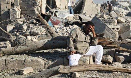 A Syrian man cries as he sits on the rubble Aleppo