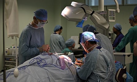 A surgeon performs a neck and throat operation in the recently opened Birmingham Queen Elizabeth Hos