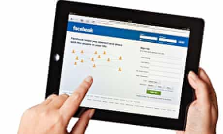 Facebook - Female hands holding iPad2 using the Facebook website