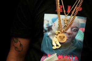 photo of a man's torso with a t shirt and gold chains around his neck