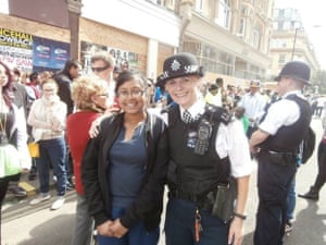 a girl standing next to a policewoman