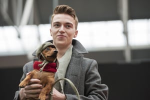 An owner holds his small dog during the PAw Pageant.