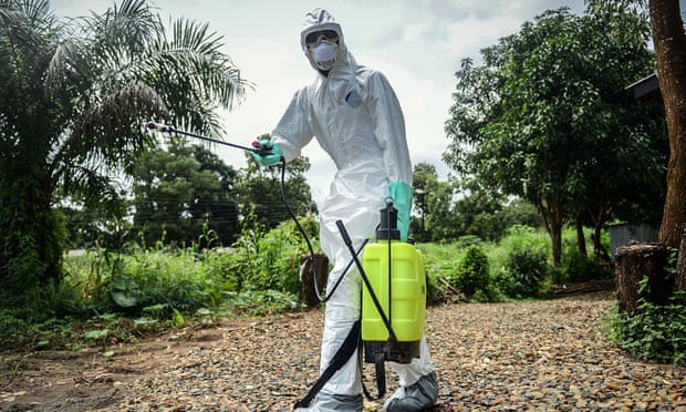 A volunteer sterilises the bodies of Ebola victims ahead of their burials in Kenema, Sierra Leone.