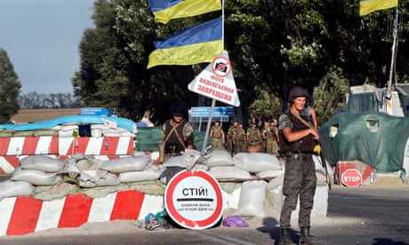 Ukrainian soldiers guard a checkpoint in Mariupol in eastern Ukraine