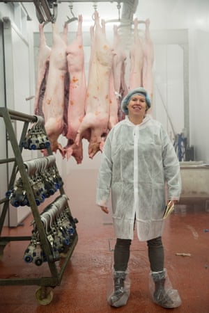 Allegra is suited and booted near pig carcasses.