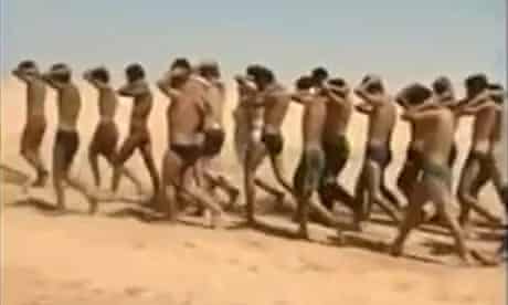 An image grab taken from a video uploaded on social networks alleged captured soldiers being marched