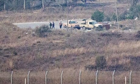 Armed men, reportedly Syrian rebels, standing near the Quneitra border crossing in the Golan Heights