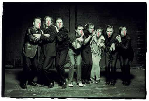 The Bad Seeds (Martyn P Casey, Conway Savage, Mick Harvey, Nick Cave, Jim Sclavunos, Warren Ellis, Thomas Wydler, Blixa Bargeld) photographed on the set of 'Babe. I'm On Fire' at Three Mills Studios, Bromley-by-Bow, east London, on 19 September 2002 by Bleddyn Butcher