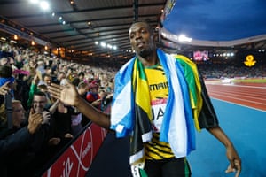 Usain Bolt greets fans after winning the 4x100m final for Jamaica during the Commonwealth Games in Glasgow