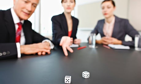 Business people throwing dice on conference room table. 