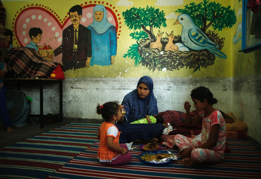 A Palestinian woman and two girls, at a United Nations-run school in Gaza, July, 2014.