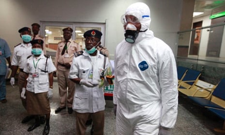 Nigerian health officials wait to screen passengers for the Ebola virus after arrival at Murtala Muhammed International Airport in Lagos, Nigeria. Nigerian authorities confirmed a second case of Ebola in the country.