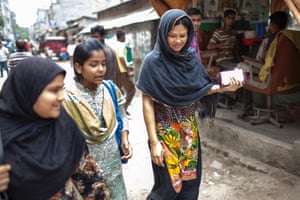 Nahid Parvin walks with Farzana Naz, a young mother from the Urdu-speaking minority in Bangladesh. Farzana has applied for a passport so she can take a job as a domestic worker in Saudi Arabia to support her daughters through the rest of their schooling. Nahid is helping with her case.
