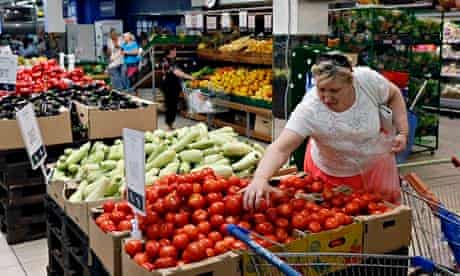 A Russian woman buys tomatoes at a Moscow supermarket