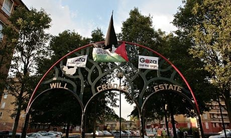 The Isis flag outside the Poplar housing estate, surrounded by a Palestine flag and Gaza placards