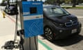 A BMW i3 electric car and charger is shown at the Electric Power Research Institute's Plug-In 2014 conference in San Jose, California