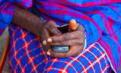 Maasai tribesman using a mobile phone