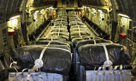 Pallets of bottled water are loaded on board a US Air Force plane for an airdrop to Iraqi refugees